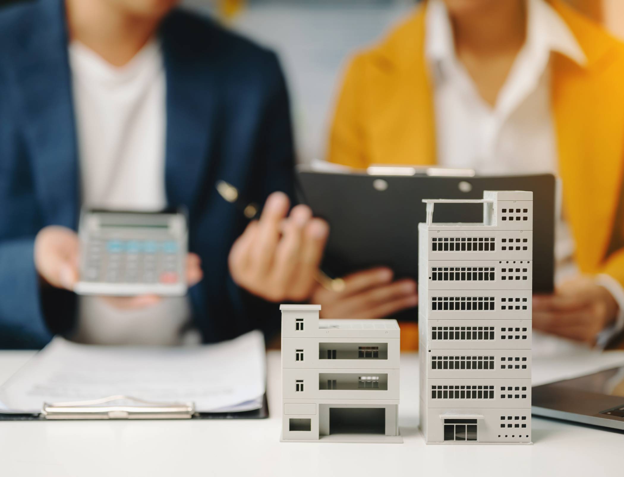 Construction cost management professional reviewing project budget and financial forecasts for a real estate development.